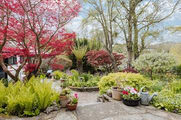 The fully enclosed garden is magical, with a hidden seat around a corner by the brook, as well as the patio outside the cottage.
