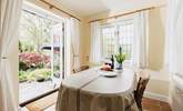 With windows on two sides and French doors to the garden, the dining-room is a bright and sunny room. - Thumbnail Image