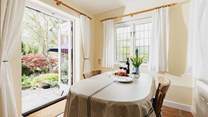 With windows on two sides and French doors to the garden, the dining-room is a bright and sunny room.