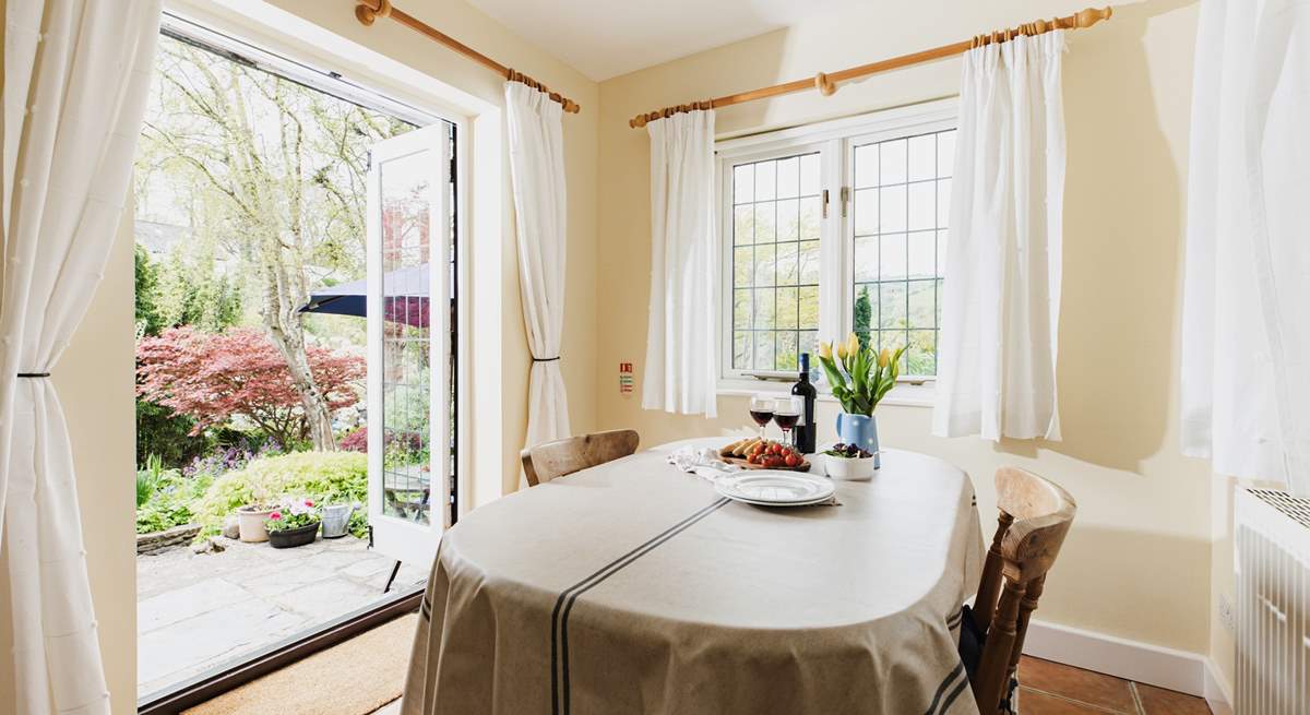 With windows on two sides and French doors to the garden, the dining-room is a bright and sunny room.