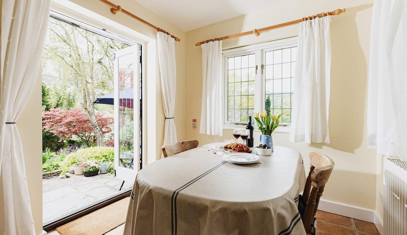 With windows on two sides and French doors to the garden, the dining-room is a bright and sunny room.