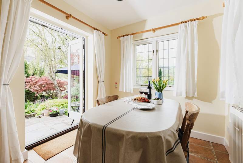 With windows on two sides and French doors to the garden, the dining-room is a bright and sunny room.