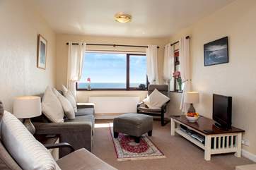 The spacious sitting/dining-room takes full advantage of the view.