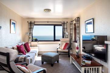 The spacious sitting/dining-room takes full advantage of the view.