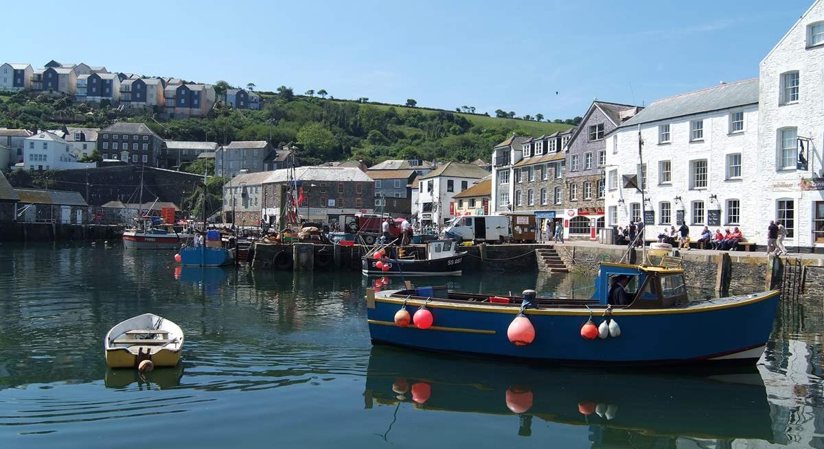 Fishing boats unload on Mevagissey harbourside.