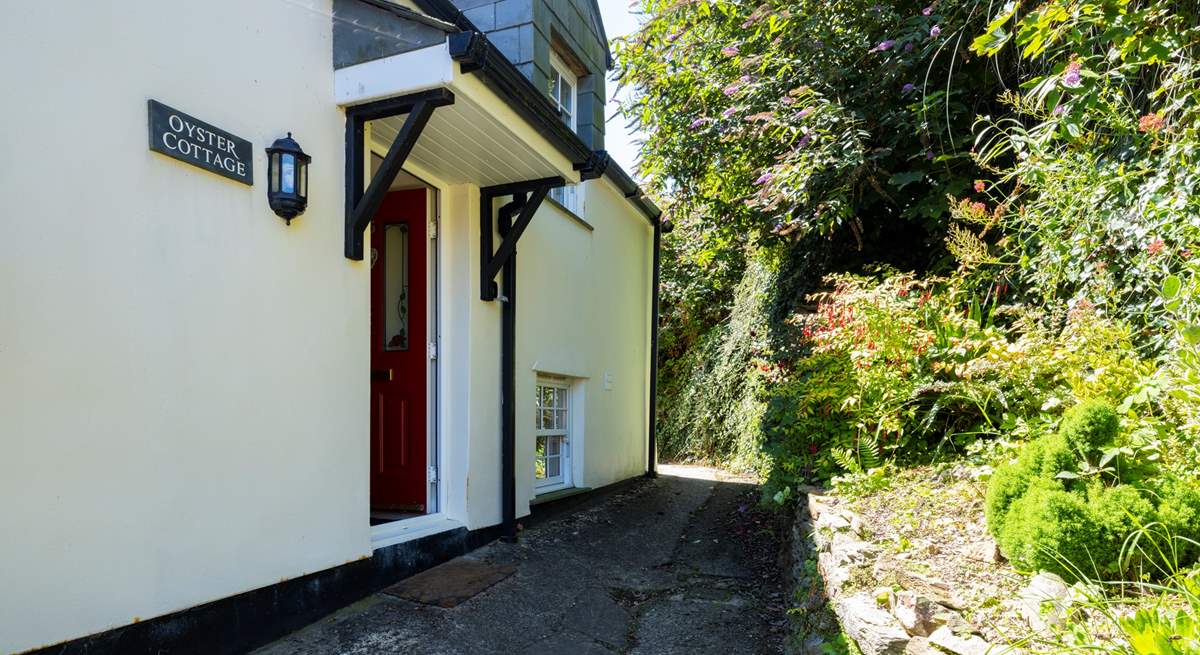 A shallow flight of steps lead from the parking-area to Oyster Cottage, a modern end-of-terrace property much bigger in reality than it looks in the picture.