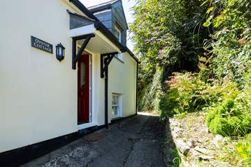 A shallow flight of steps lead from the parking-area to Oyster Cottage, a modern end-of-terrace property much bigger in reality than it looks in the picture.