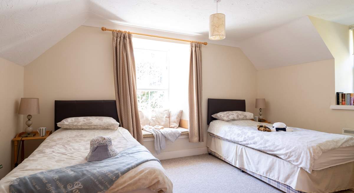 Bedroom 2 has twin beds and a window seat perfect for some reading.