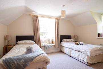 Bedroom 2 has twin beds and a window seat perfect for some reading.