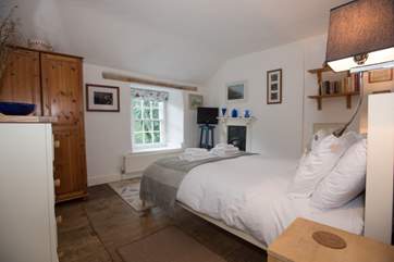 The bedroom is welcoming and spacious.