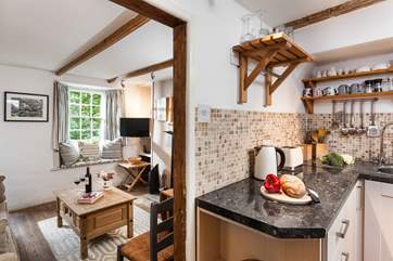 The sitting room leads into the kitchen.