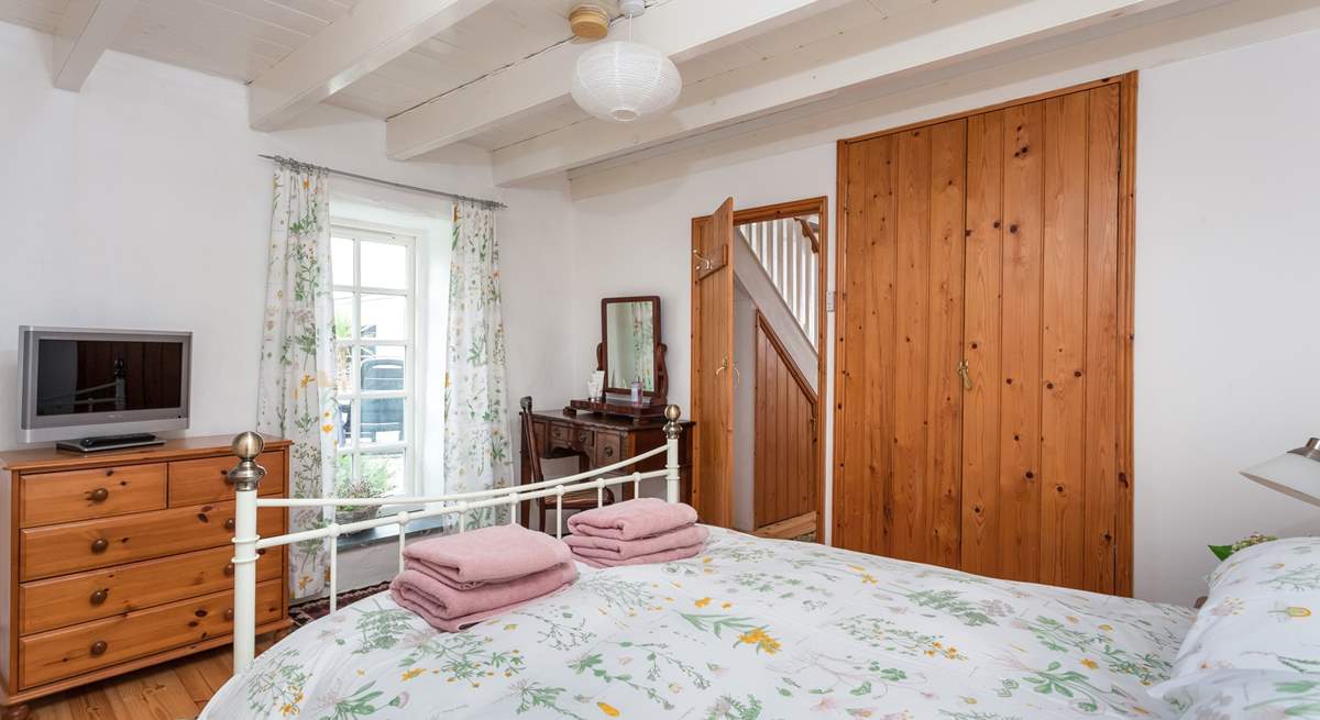 The master bedroom has doors that open to the patio.