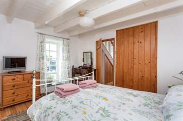The master bedroom has doors that open to the patio.