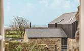 The view out of the kitchen window over a converted barn and to the rolling countryside and sea beyond.  - Thumbnail Image