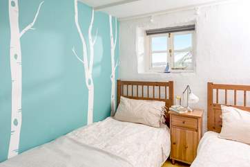 The twin bedroom has fun decor.