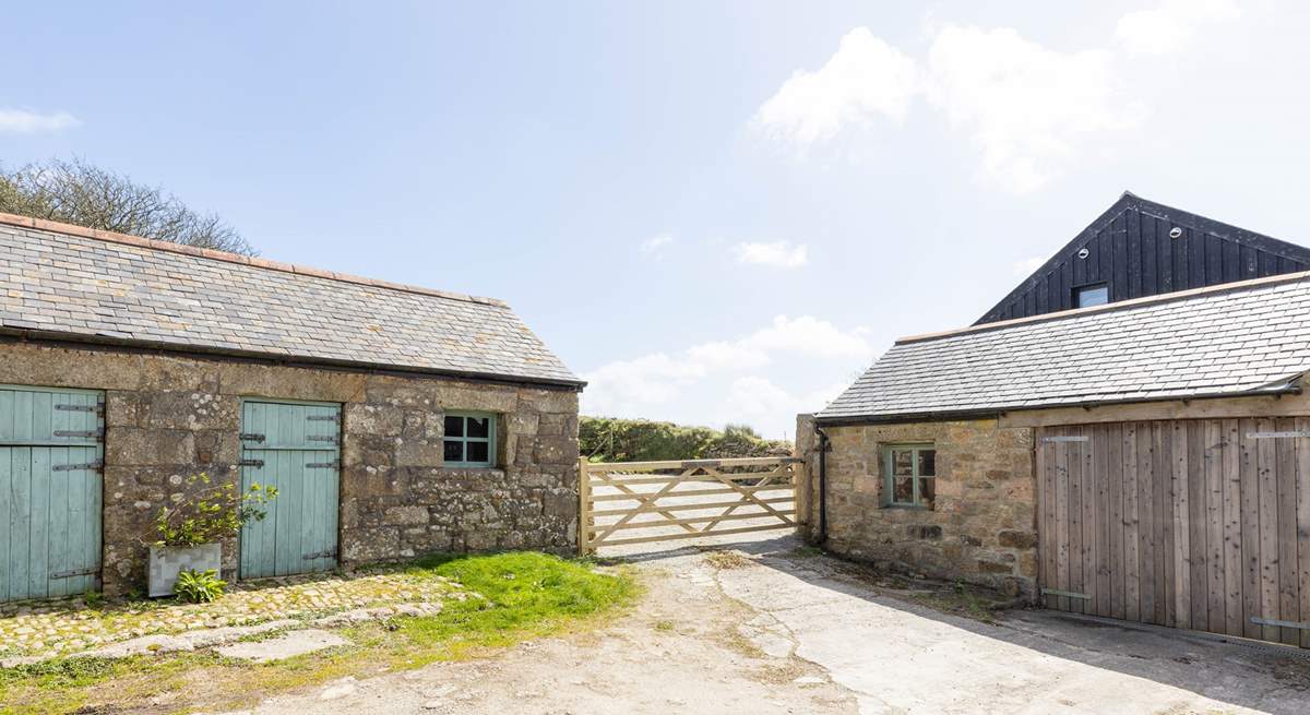 The entrance to the cottage parking with the laundry-room for Little Trebarvah in the single-storey barn on the left, the owners share access at the bottom of this drive. 