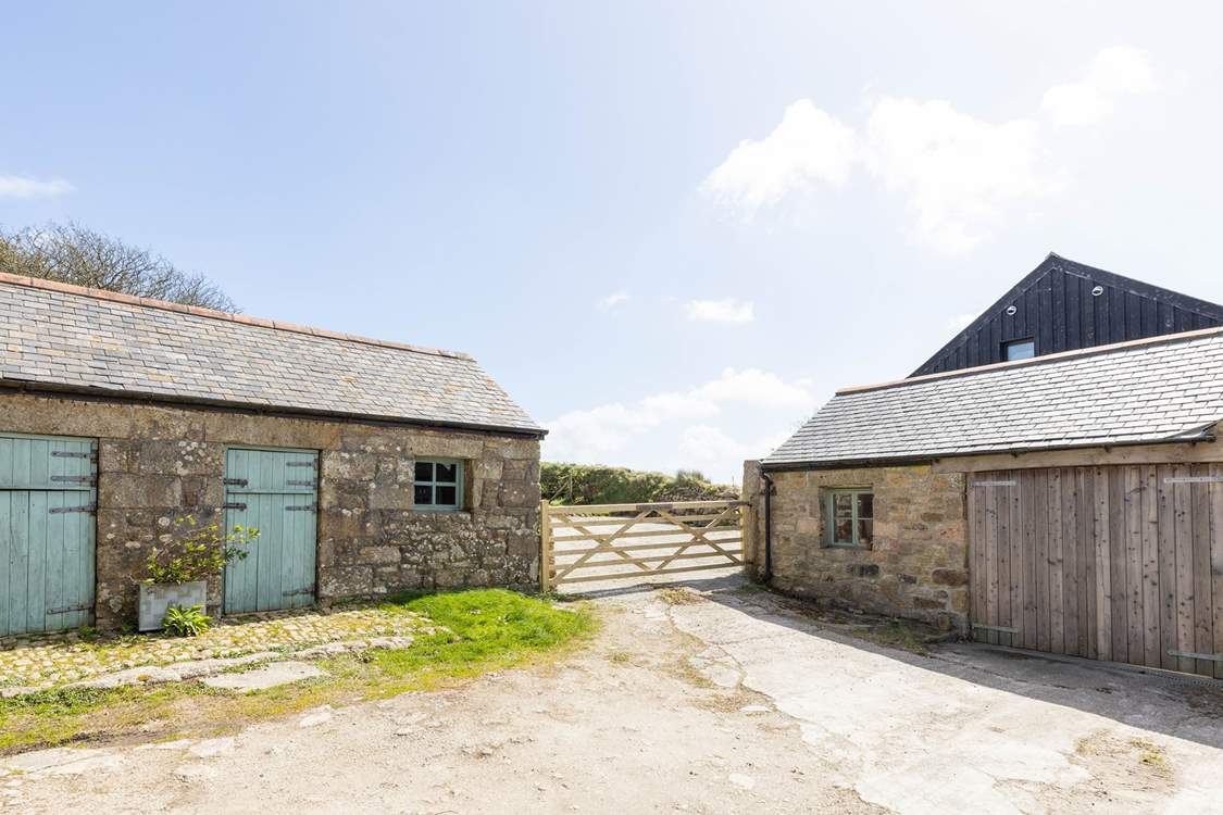 The entrance to the cottage parking with the laundry-room for Little Trebarvah in the single-storey barn on the left, the owners share access at the bottom of this drive.