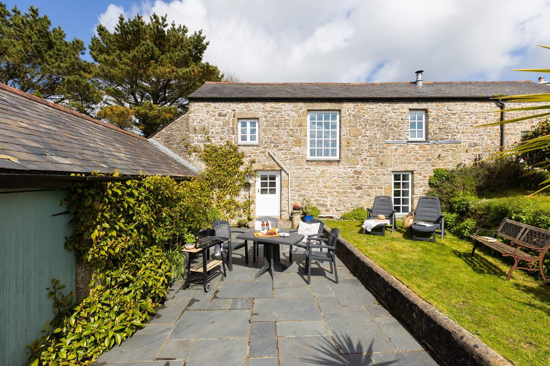 Little Trebarvah's south-facing garden is a peaceful spot from which to admire the countryside views. 