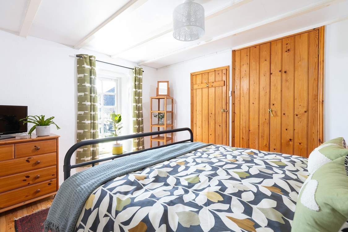 The bedroom has a fabulous window overlooking the patio.