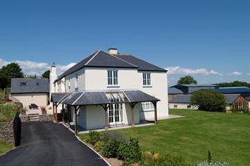 The exterior of the property. There is a patio-area at the front, as well as one outside the kitchen at the back of the house.