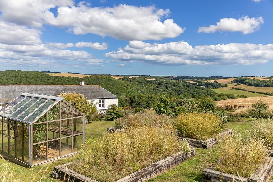 The farmhouse is in a stunning location. The kitchen garden includes wild flowers in the planters.