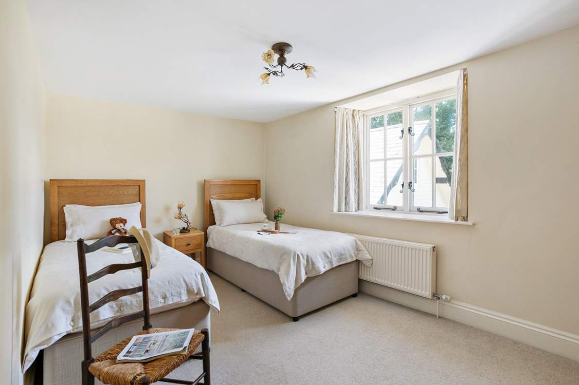 Bedroom five is home to two delightful single beds.