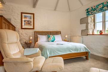Lounge in bed, enjoying the light space with high ceilings or snuggle up and watch TV.
