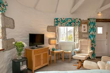 There are two comfy chairs and a footstool when you want to relax after dinner.