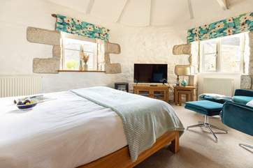 Lounge in bed, enjoying the light space with high ceilings or snuggle up and watch TV.