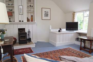 The sitting-room is on the first floor and has a cosy wood-burner.