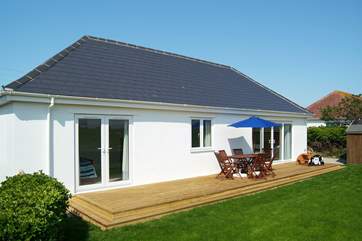 The sunny decking at the back of the property is lovely and private and has views over the fields to the sea beyond.