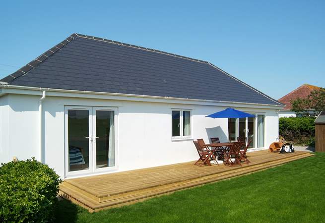 The sunny decking at the back of the property is lovely and private and has views over the fields to the sea beyond. 