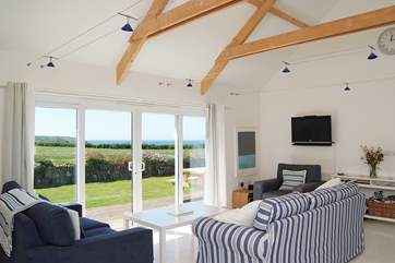 Patio doors lead out to the deck and lawned back garden.
