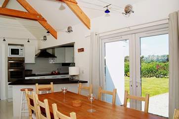 Beside the dining-table, there are patio doors which open out to the front garden.