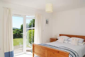 The master bedroom (Bedroom 2) has a king-size bed, an en suite shower-room, and patio doors opening onto the deck in the back garden.