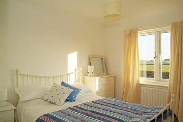 Bedroom 1 has a lovely white metal-framed double bed.
