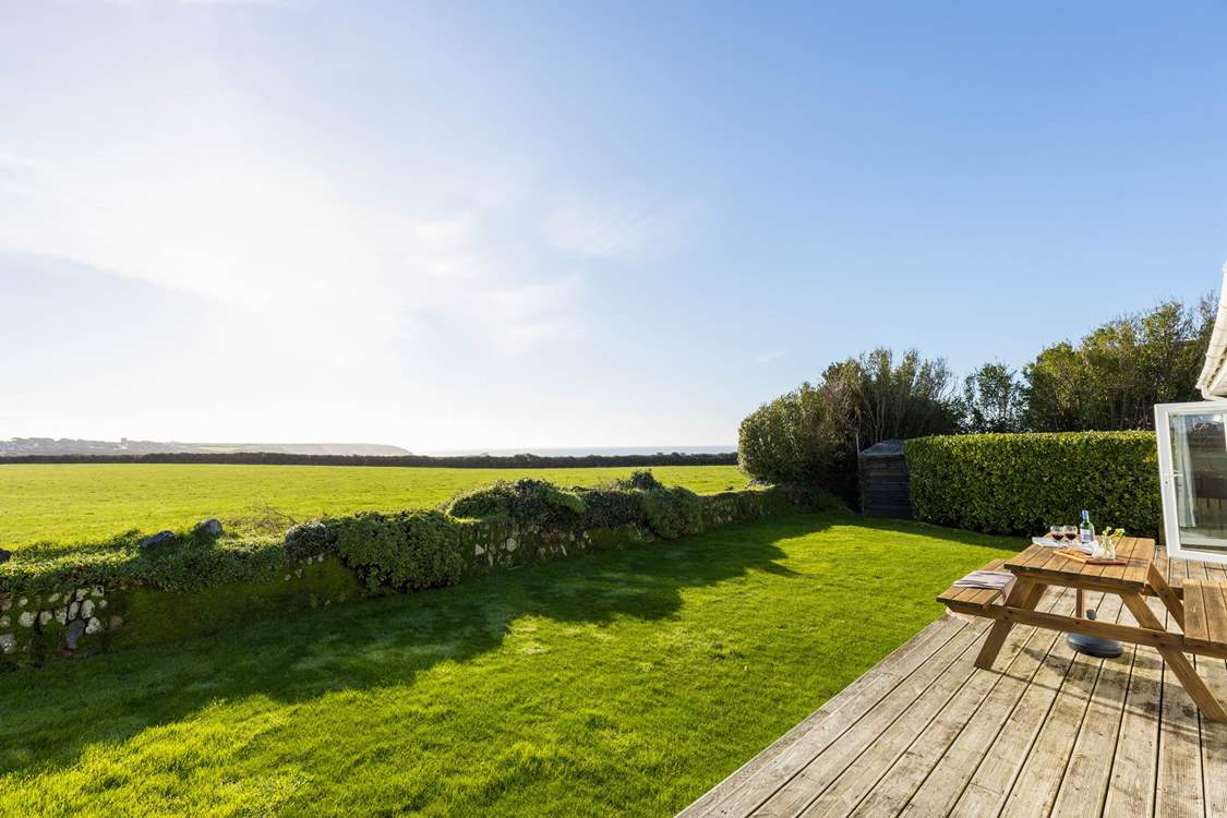 Spectacular views across National Trust fields to the glistening sea beyond.