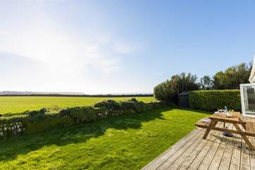 Spectacular views across National Trust fields to the glistening sea beyond,