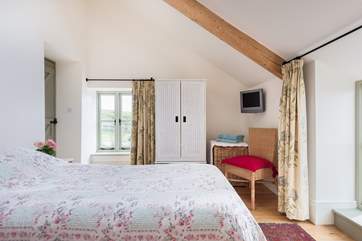 This light room is across the hallway from the other bedroom with the bathroom in between.