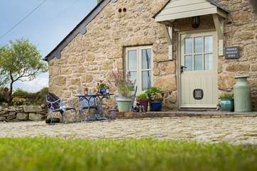 The table to the front of the cottage is a sunny spot to sit and not too far from the fridge.
