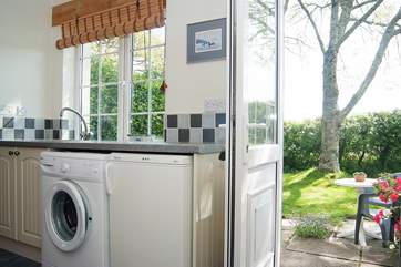 The utility-room acts as a useful entrance hall with space for coats and bags.