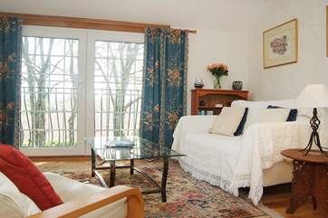 The open plan living-room has French doors and a Juliet balcony.