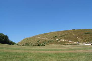 Brave the coastal path to Durdle Door - over the brow of the hill the stunning view of this famous Dorset landmark will be well worth the effort.
