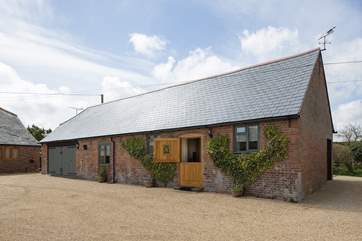 The Stables offers plenty of level parking, surrounded by beautiful gardens, the owner's house is to the left.