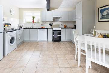 The bright kitchen with dining-area has plenty of space.