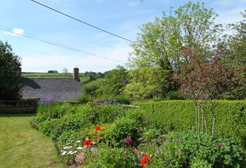 The beautifully looked after garden looks out over the top of the village to the stunning views across the valley.