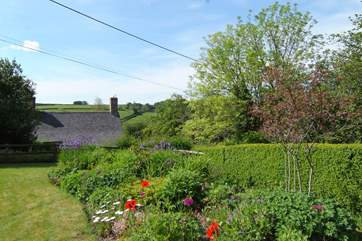 The beautifully looked after garden looks out over the top of the village to the stunning views across the valley.