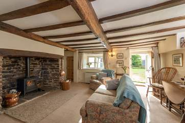 The sitting-room has a fabulous inglenook fireplace and a door that takes you out to the patio and garden.