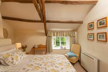 Both the master and twin bedrooms look out over the pretty garden and the view across the valley beyond