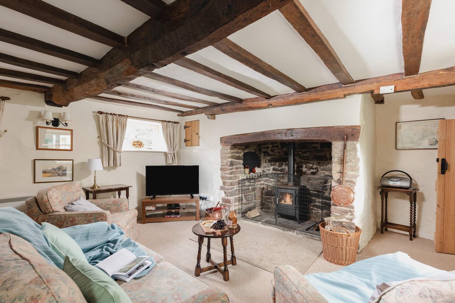 The sitting-room has a fabulous inglenook fireplace and a door that takes you out to the patio and garden.